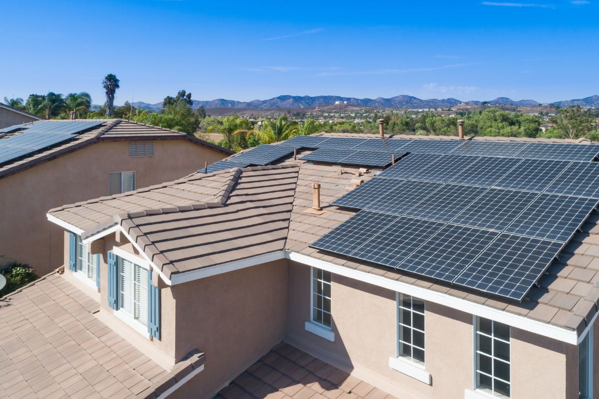 Solar panels installed on the roof of a residential house, showcasing renewable energy technology in a suburban setting.